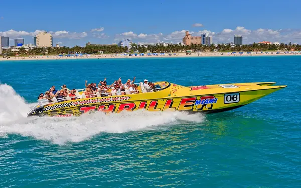 Thriller's yellow speedboat with tour group on the water