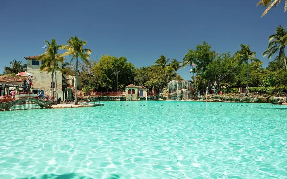 View of waterfall and grotto across Venetian Pool's clear water