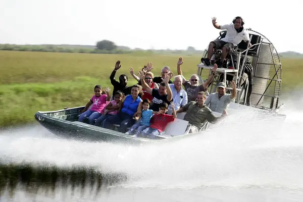 Visitors ride through the Everglades on a guided airboat tour
